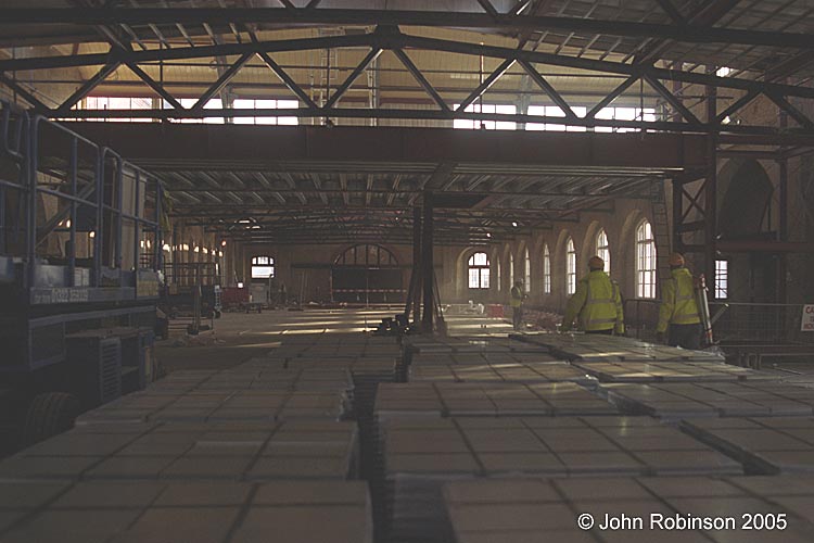 Looking east along Drill Hall, piles of floor tiles in foreground
