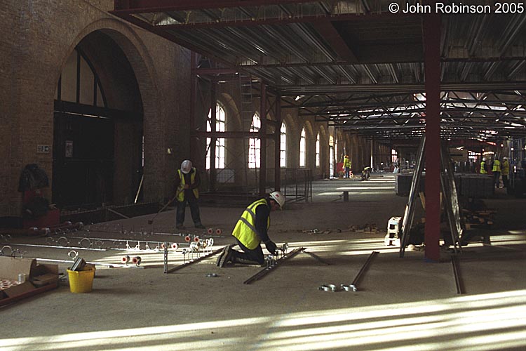Looking west along Drill Hall from east end, work commencing on under-floor pipework